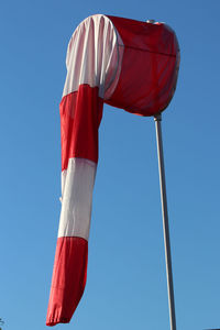 Low angle view of flag against blue sky