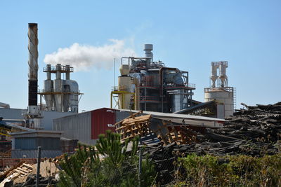 View of factory against cloudy sky