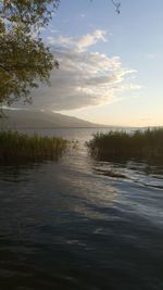 Scenic view of lake against sky during sunset