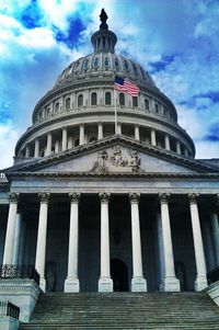 Low angle view of historical building against cloudy sky