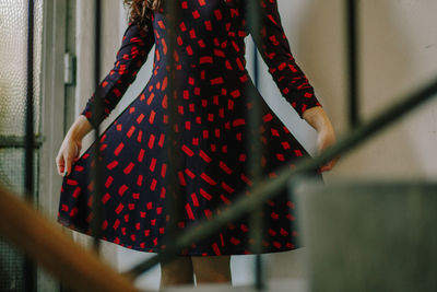 Midsection of man with red umbrella