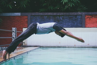 Man jumping in swimming pool