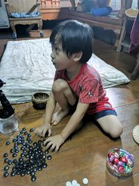 High angle view of boy sitting on table at home