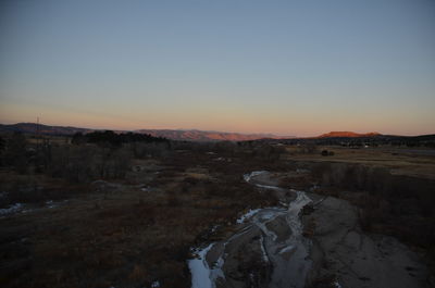 Scenic view of landscape against clear sky during sunset