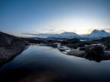 Scenic view of lake and mountains against sky