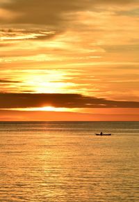 Scenic view of sea against orange sky