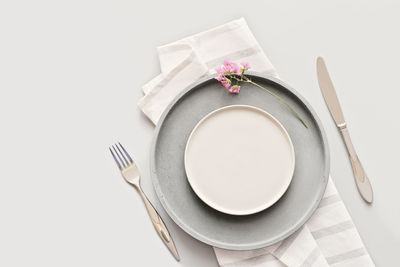 Empty  plates on a table with fork and knife. trendy nordic minimal style tableware. menu mock up. 