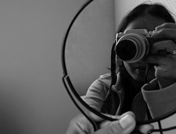 Close-up of man photographing camera