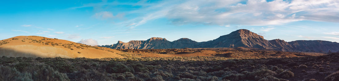 Panoramic view of arid landscape against sky