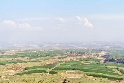 Scenic view of field against cloudy sky