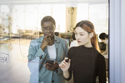 Multiracial female colleagues brainstorming in creative office