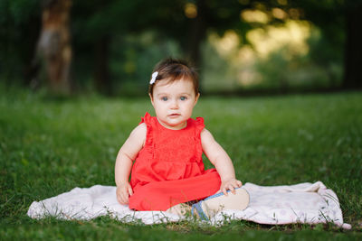 Cute girl sitting on field