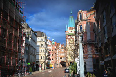 Street amidst buildings in city against sky