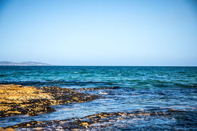 Scenic view of sea against clear sky