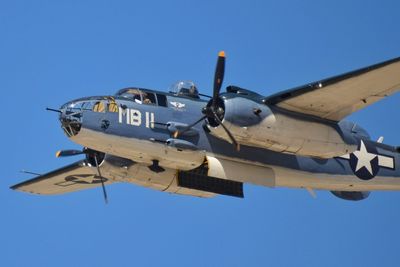 Airplane flying against clear blue sky