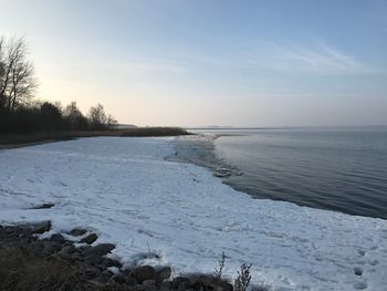 Scenic view of frozen lake against sky