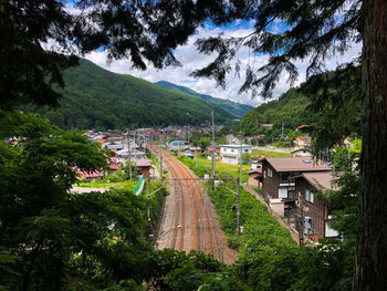 High angle view of road amidst trees and buildings