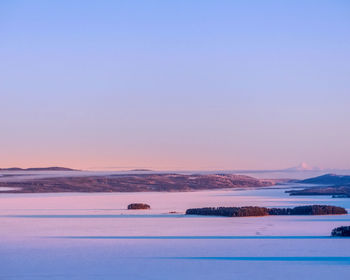 Scenic view of sea against clear sky during sunset