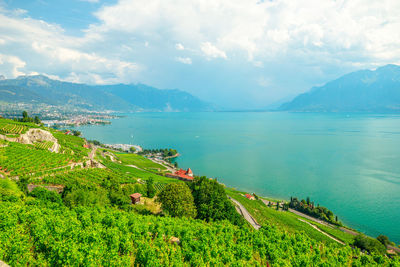 Scenic view of sea and mountains against sky