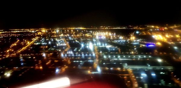 High angle view of illuminated city buildings at night