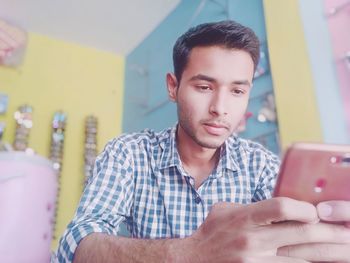 Portrait of young man using mobile phone