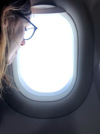 Woman looking through airplane window
