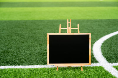 Blank blackboard on playing field