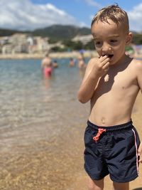 Portrait of boy standing at beach