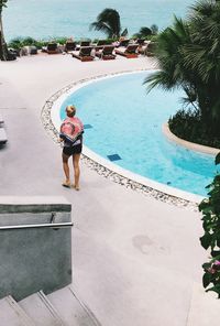 Rear view of woman in swimming pool