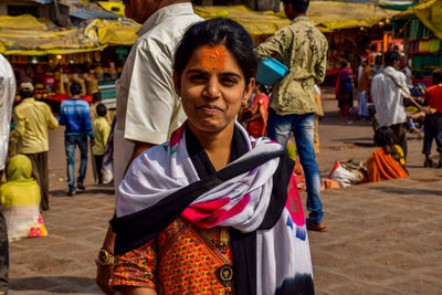 Portrait of smiling woman standing in market