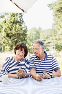 Mature couple with cell phones