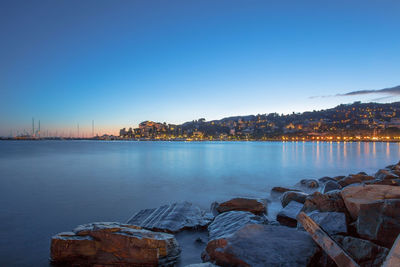 Scenic view of lake against clear blue sky