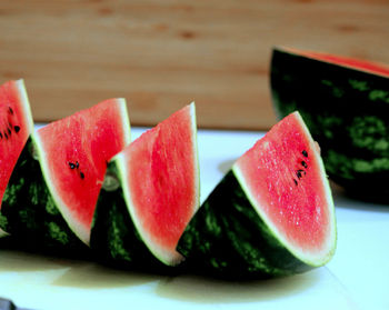 Close-up of chopped fruits in plate on table