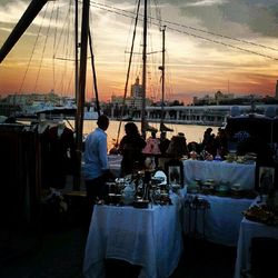 Boats in harbor at sunset