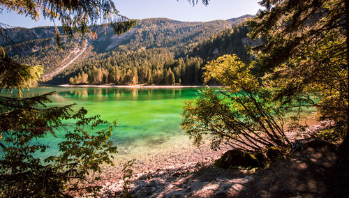 Calm countryside lake against mountain range