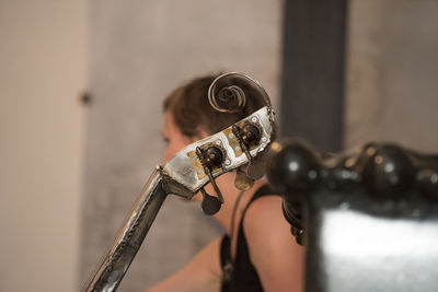 Portrait of young woman playing guitar