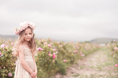 Portrait of girl standing on field