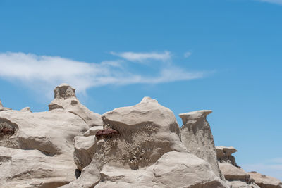 Low angle view of rock formation against sky