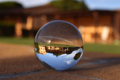 Close-up of crystal ball on glass of building