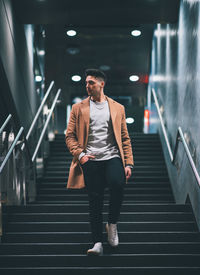 Full length of man standing on staircase