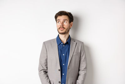 Portrait of young man against white background