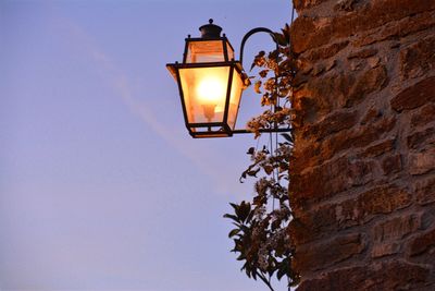 Low angle view of illuminated street light against clear sky