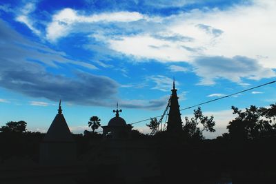 Low angle view of silhouette temple against sky