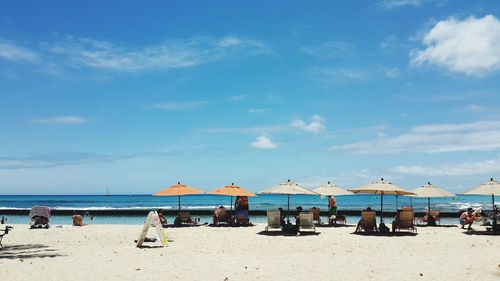 Scenic view of beach against blue sky