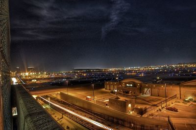 Illuminated cityscape against sky at night