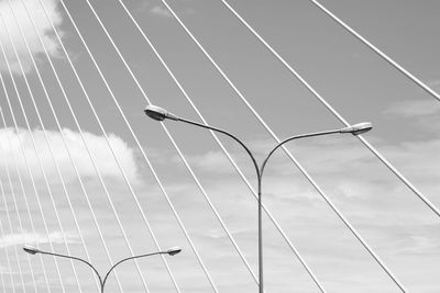 Low angle view of suspension bridge against sky