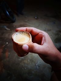 Cropped image of hand holding chai
