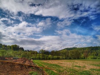 Scenic view of agricultural field against sky