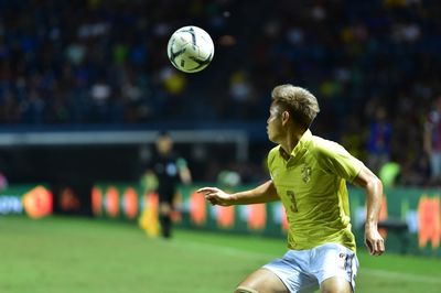 Full length of young man playing soccer ball