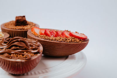 Close-up of cupcakes on table against white background